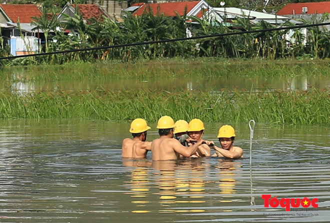 Xúc động hình ảnh công nhân ngâm mình trong nước khôi phục điện